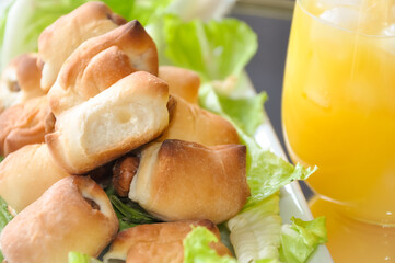 Sausage rolls and orange juice