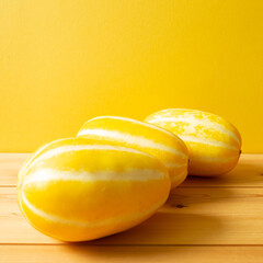 Korean oriental melon on wooden table. with yellow background