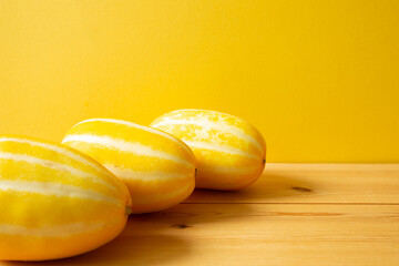 Korean oriental melon on wooden table. with yellow background