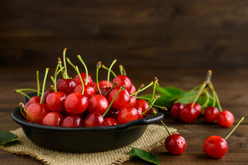 Sweet cherries in a black bowl