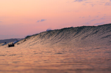 Sunrise in Japan while swimming in the Ocean amongst the waves on the Pacific coast line close to Tokyo city. The sky is stunning & shows why its called the Land of the rising sun.