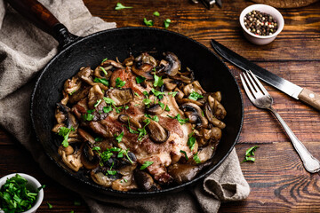 Fried pork neck steak with different mushrooms