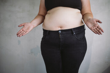 Overweight bewildered woman throwing up hands. Dieting, weight loss and health care concept. Copy...