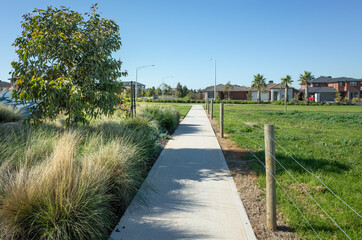 A pedestrian walkway/footpath leads to a residential neighbourhood with some modern Australian...