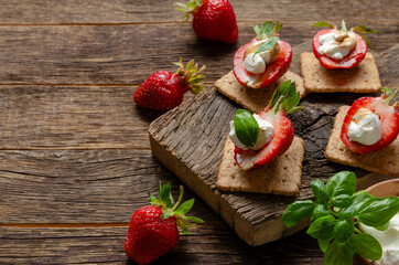 cutting board with fresh strawberry with cream cheese, balsamic vinegar and