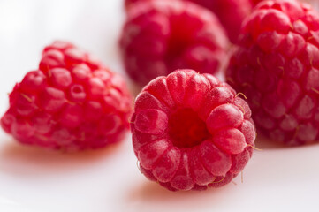 raspberries on a white saucer close up