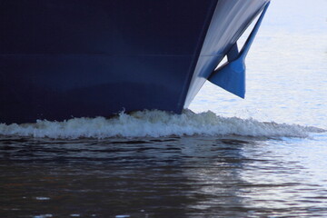 Bow keel wave and shipboard with anchor of blue passenger liner cruise ship closeup front view on summer day - boat travel vacation,  tourism