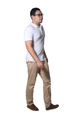 Naklejka premium Full length portrait of Asian man wearing white shirt and khaki jeans standing walking, side view profile
