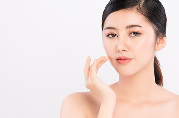 Obraz na płótnie Canvas Close up Beautiful Young asian Woman touching her clean face with fresh Healthy Skin, on white background, Beauty Cosmetics and Facial treatment Concept