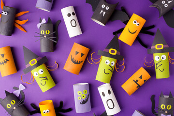 Halloween and decoration concept - monsters from toilet paper roll tube. Simple easy diy creative idea. Eco-friendly reuse recycle decor, kindergarten paper craft, seasonal holiday banner, flyer