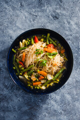 plant-based food, vegan singaporean laksa soup with vermicelli noodles and stir fry veggies