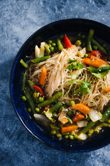 plant-based food, vegan singaporean laksa soup with vermicelli noodles and stir fry veggies