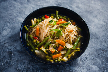 plant-based food, vegan singaporean laksa soup with vermicelli noodles and stir fry veggies