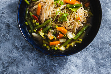 plant-based food, vegan singaporean laksa soup with vermicelli noodles and stir fry veggies