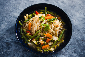 plant-based food, vegan singaporean laksa soup with vermicelli noodles and stir fry veggies
