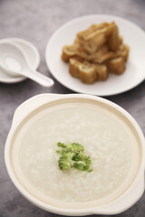 Chinese rice congee with pieces of fried bread sticks