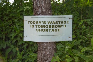 environmental conservation sign on a tree in the forest 