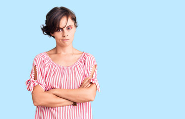 Beautiful young woman with short hair wearing casual summer clothes skeptic and nervous,...