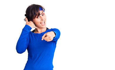 Beautiful young woman with short hair wearing training workout clothes smiling doing talking on the...