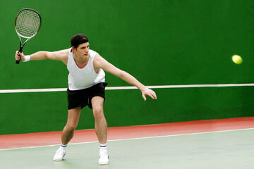 A man playing tennis in the tennis court