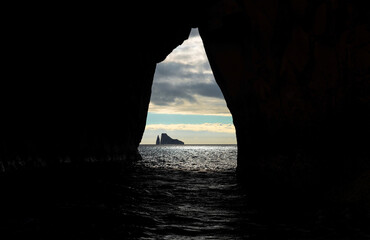 Kicker Rock seen from a cave at sunset near San Cristobal island in the Pacific Ocean, Galapagos national park, Ecuador.