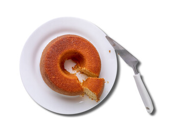 cornmeal cake with cut slice on plate isolated on white background