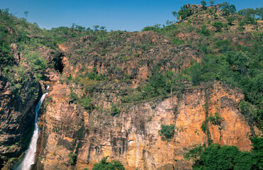 Fototapeta na wymiar Frontal panoramic view of Tolmer Falls. Dry season. Vintage coloured. Isolated location at Litchfield national park, Northern Territory NT, Australia