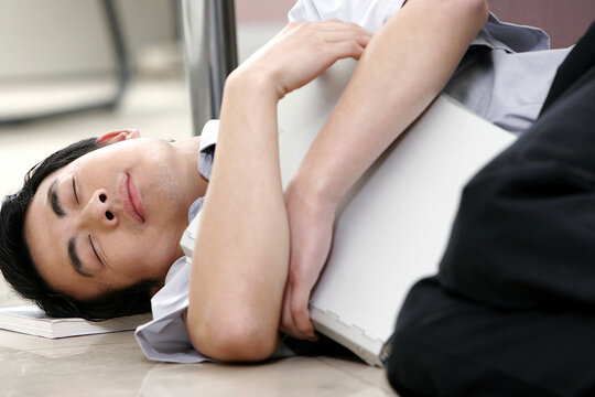 A man lying on the ground sleeping