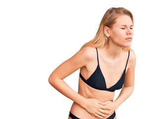 Fototapeta premium Young beautiful blonde woman wearing bikini with hand on stomach because indigestion, painful illness feeling unwell. ache concept.