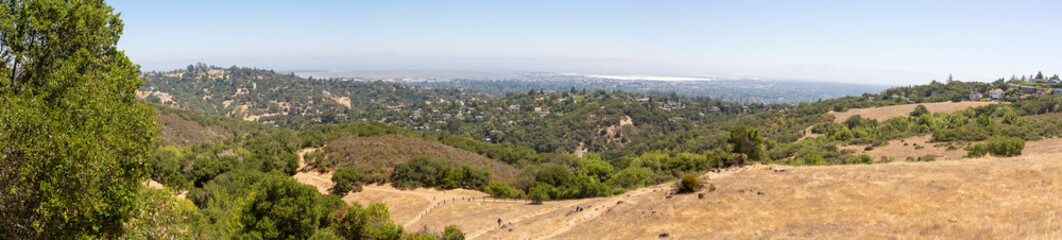 Panorama. Rural summer landscape with a road, field and forest. Hot summer day, blue sky. Rural path. Panoramic view. View from above. California, Edgewood  Park
