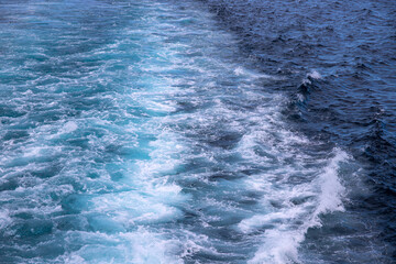 Sea water splash after motor boat. Seascape perspective view. Maritime transportation on cruise ship or motor boat