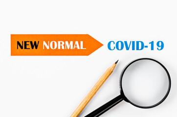 Time for a new normal with magnigying glass on paper.