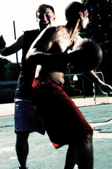 A man trying to stop his opponent from scoring