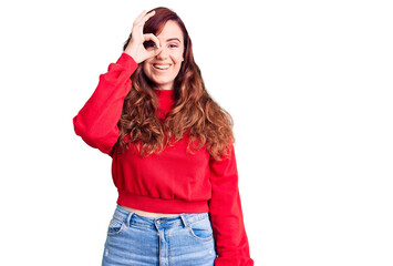 Young beautiful woman wearing casual winter sweater doing ok gesture with hand smiling, eye looking through fingers with happy face.