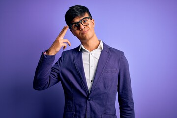 Young handsome business man wearing jacket and glasses over isolated purple background Shooting and killing oneself pointing hand and fingers to head like gun, suicide gesture.