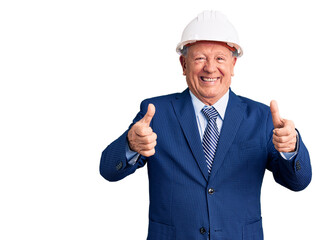 Senior handsome grey-haired man wearing suit and architect hardhat success sign doing positive gesture with hand, thumbs up smiling and happy. cheerful expression and winner gesture.