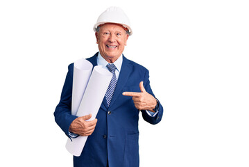 Senior handsome grey-haired man wearing architect hardhat holding blueprints smiling happy pointing with hand and finger