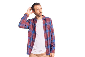 Young handsome man wearing casual clothes confuse and wondering about question. uncertain with...