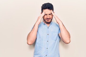 Young hispanic man wearing casual clothes with hand on head, headache because stress. suffering migraine.