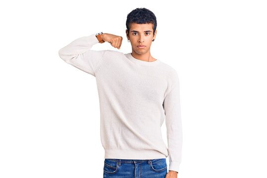 Young african amercian man wearing casual clothes strong person showing arm muscle, confident and proud of power