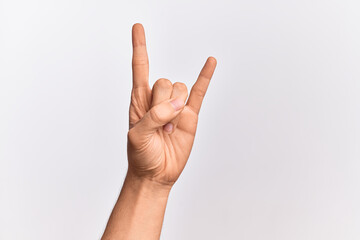 Hand of caucasian young man showing fingers over isolated white background gesturing rock and roll...