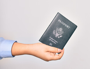Hand of caucasian young woman holding united states passport document over isolated white background