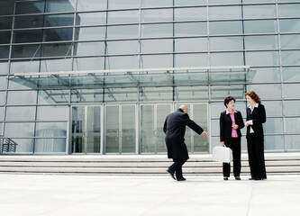 A bald man trying to snatch a woman's briefcase