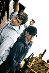 Two boys posing beside a truck