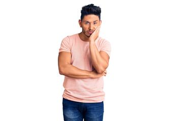 Handsome latin american young man wearing casual clothes thinking looking tired and bored with...