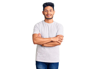 Handsome latin american young man wearing casual tshirt happy face smiling with crossed arms looking at the camera. positive person.