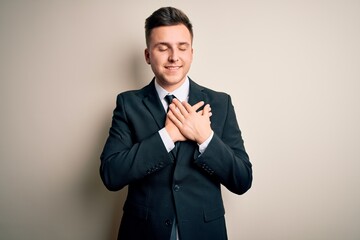 Young handsome business man wearing elegant suit and tie over isolated background smiling with...