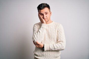 Young handsome caucasian man wearing casual winter sweater over white isolated background thinking looking tired and bored with depression problems with crossed arms.