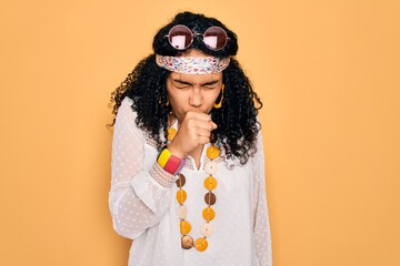 Young african american curly hippie woman wearing sunglasses and vintage accessories feeling unwell and coughing as symptom for cold or bronchitis. Health care concept.