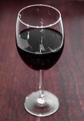 Glass of merlot wine with background
